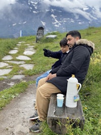 a man and a child sitting on a bench