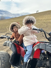 two children on a four wheeler