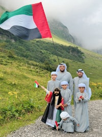 a group of people holding a uae flag