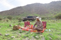 a man sitting on a blanket