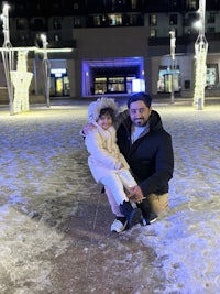 a man and a child posing in the snow